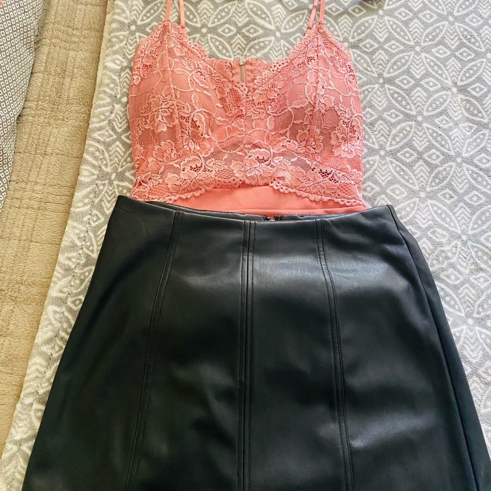 Two pink shirts and a leather skirt